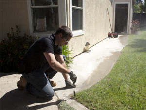 an irrigation contractor in Spring, TX makes adjustments to a Rain Bird pop up head