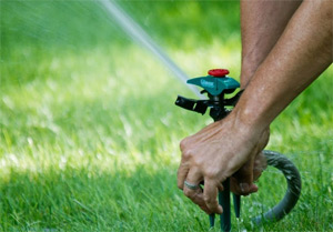 Irrigation contractor in Spring, TX adjusts a turf rotor